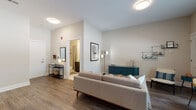 Located at 310 Madison in Elizabeth, NJ, this single-floor residence offers a thoughtfully designed layout with modern finishes throughout. Rich hardwood-style flooring flows seamlessly across the living spaces, creating a cohesive and warm aesthetic.

The living room is open and welcoming, featuring neutral walls, ample ceiling lighting, and a large window that invites natural light and outdoor views. The space comfortably accommodates a full seating arrangement alongside a dining area, making it ideal for both relaxing and entertaining.

The kitchen is outfitted with full-height dark cabinetry, white quartz countertops, a subway tile backsplash, and a complete suite of stainless steel appliances, including a gas range, dishwasher, microwave, and refrigerator.

The bedroom is generously proportioned, with multiple windows dressed in sheer curtains that flood the room with natural light. Crown molding adds a refined touch, and the space provides ample room for a full bedroom suite.

The bathroom features marble-style tile flooring and tub surround, a dark wood vanity with a white countertop, and a large mirror with overhead lighting, delivering a clean, contemporary finish.

A closet with louvered doors and convenient entry access complete this well-appointed residence.