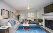This single-floor residence offers a thoughtfully designed layout that balances comfort and functionality throughout. The expansive living room serves as the heart of the home, featuring wood-style flooring, large windows that invite generous natural light, and a classic fireplace framed by a clean white mantel — an ideal focal point for the room. The open, airy atmosphere is complemented by a textured ceiling and a central light fixture.

The galley-style kitchen is efficiently arranged with white shaker cabinetry, granite-look countertops, and a full suite of appliances including a gas range, microwave, refrigerator, and dishwasher. Light wood-tone flooring continues the cohesive aesthetic throughout.

Adjacent to the kitchen, a dedicated dining area provides an intimate setting beneath a pendant light fixture, with wainscoting detail along the lower walls adding a refined touch.

The bedroom is a serene retreat, featuring plush carpeting, a large window with views of lush greenery, and a walk-in closet offering ample storage. The full bathroom is clean and well-equipped, with white cabinetry, a granite-look vanity top, a soaking tub, and in-unit laundry access. Throughout the space, neutral tones and consistent finishes create a cohesive, welcoming environment.