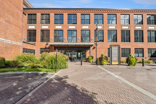 Voke Lofts community entrance with landscaped grounds and modern architectural design - Voke Lofts