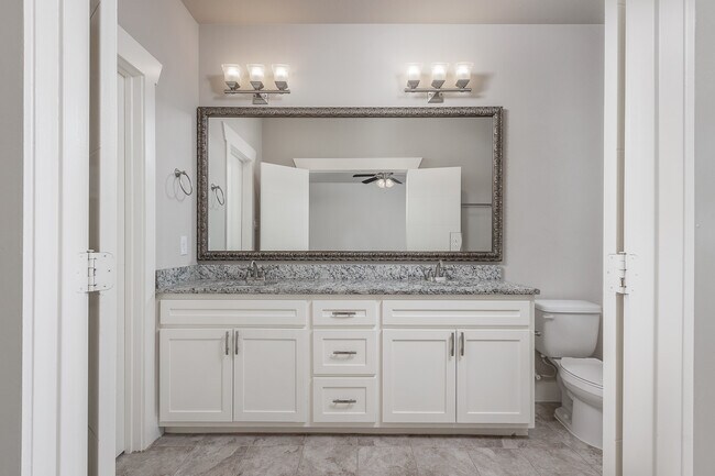Master Bath. All bathrooms have framed mirrors, and cabinet door and drawer pulls. - 305 S Kealy Ave