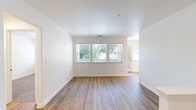 Located in Danville, CA, this single-story, 3-bedroom, 2-bathroom home offers a clean, modern aesthetic throughout. The open living area features wood-look laminate flooring and large windows that invite abundant natural light while framing views of the surrounding greenery. Crisp white walls and a textured ceiling complete the bright, airy atmosphere.

The kitchen is efficiently laid out with white cabinetry, white countertops, recessed lighting, and stainless steel appliances including a refrigerator and range. A dedicated pantry closet provides excellent additional storage. The kitchen connects seamlessly to the main living areas via wood-look flooring that flows throughout the common spaces.

The three bedrooms feature plush carpeting underfoot, with the primary bedroom offering a comfortable footprint, a ceiling fan with light fixture, and a window overlooking the outdoors. Closets with standard rod-and-shelf systems serve the bedrooms for organized storage.

The two bathrooms are cleanly appointed in white. One features a full tub-shower combo with a window for natural light, while the second includes a glass-enclosed shower stall, a white vanity, and wood-look flooring. Two hallways and additional closets throughout the home provide practical storage and smooth circulation between all rooms.