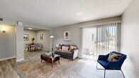 Located on E Fifth St in Tucson, Arizona, this single-story, one-bedroom, one-bathroom residence offers a thoughtfully designed layout that maximizes every inch of its compact footprint. Light-toned wood-look flooring flows throughout, complemented by neutral gray walls and textured ceilings that add character to each room.

The combined living and dining area forms the heart of the home. The living space is bright and welcoming, anchored by a large sliding glass door fitted with vertical blinds that flood the room with natural light and provide direct access to the outdoors. The adjacent dining nook offers an intimate setting for meals, with clean wall space ideal for artwork.

The galley-style kitchen is efficiently arranged, featuring white cabinetry, light countertops, a stainless steel sink, and a full suite of stainless steel appliances including a refrigerator, range, microwave, and dishwasher — delivering a modern, functional cooking environment.

The bedroom is a comfortable, quiet retreat with a window that allows natural light, a dedicated closet, and ample wall space. The full bathroom is clean and bright, complete with a tub-shower combination, a white vanity with storage, and tile flooring.

A hallway connects the private areas of the home, and the overall layout is practical and cohesive — making this Tucson residence an efficient and attractive living space.