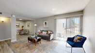 Located on E Fifth St in Tucson, Arizona, this single-story, one-bedroom, one-bathroom residence offers a thoughtfully designed layout that maximizes every inch of its compact footprint. Light-toned wood-look flooring flows throughout, complemented by neutral gray walls and textured ceilings that add character to each room.

The combined living and dining area forms the heart of the home. The living space is bright and welcoming, anchored by a large sliding glass door fitted with vertical blinds that flood the room with natural light and provide direct access to the outdoors. The adjacent dining nook offers an intimate setting for meals, with clean wall space ideal for artwork.

The galley-style kitchen is efficiently arranged, featuring white cabinetry, light countertops, a stainless steel sink, and a full suite of stainless steel appliances including a refrigerator, range, microwave, and dishwasher — delivering a modern, functional cooking environment.

The bedroom is a comfortable, quiet retreat with a window that allows natural light, a dedicated closet, and ample wall space. The full bathroom is clean and bright, complete with a tub-shower combination, a white vanity with storage, and tile flooring.

A hallway connects the private areas of the home, and the overall layout is practical and cohesive — making this Tucson residence an efficient and attractive living space.