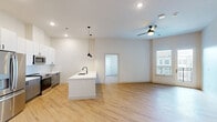 Located at 212 Durham Ave in Metuchen, NJ, this well-appointed 2-bedroom, 2-bathroom residence offers a thoughtfully designed single-floor layout with modern finishes throughout. Light hardwood flooring flows seamlessly across the entire unit, creating a warm and cohesive aesthetic.

The open-concept kitchen and living area serves as the heart of the home. The kitchen is outfitted with sleek two-tone cabinetry — white uppers and gray lowers — paired with white quartz countertops, a subway tile backsplash, and stainless steel appliances including a French door refrigerator, electric range, and built-in microwave. A peninsula with pendant lighting provides additional prep space and casual seating.

The living room opens to a private balcony through a glass door, offering outdoor views of the surrounding community and courtyard below. Both bedrooms are bright and airy, featuring large windows with exterior views and ample closet space. The primary bedroom is generously sized with dedicated storage.

Each bathroom is finished with gray vanity cabinetry, white quartz countertops, large mirrors, and matte black fixtures, lending a clean, contemporary feel. A dedicated laundry room houses a full-size side-by-side washer and dryer. Two closets provide additional storage throughout the unit.
