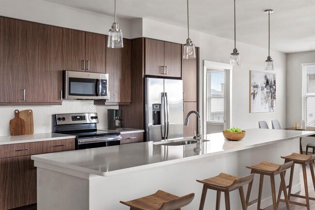 Gourmet Kitchen with Stainless Steel Appliances and Pendant Lighting - Gateway Arvada Ridge