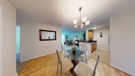 Located at 13222 E Iliff Ave in Aurora, CO, this well-appointed 2-bedroom, 2-bathroom residence offers a thoughtfully designed single-floor layout. The open-concept living and dining area is anchored by warm hardwood-style flooring and a stylish chandelier above a glass-top dining table, creating an inviting space for entertaining. A large closet with double doors provides generous storage just off the dining area.

The kitchen features dark granite countertops, a peninsula with bar seating, light maple cabinetry with upper storage reaching to the ceiling, stainless steel appliances including a refrigerator and electric range, and a double-basin sink — all flowing seamlessly into the living area, which is brightened by a large window and access to a private balcony.

Both bedrooms are carpeted and comfortably sized, with the primary bedroom offering a dedicated walk-in style closet. The two bathrooms are well-appointed with granite-topped vanities, white cabinetry, and tub/shower combinations. Throughout the residence, neutral tones and clean finishes contribute to a bright, cohesive ambiance. Three closets in total ensure abundant storage across the home.