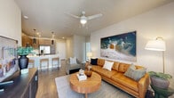 Located at 604 Vistera Blvd in North Venice, FL, this 2-bedroom, 2-bathroom residence offers a thoughtfully designed single-floor layout that maximizes both comfort and functionality. The open-concept living, dining, and kitchen area forms the heart of the home, where wood-look flooring, neutral tones, and abundant natural light create a warm and inviting atmosphere. A ceiling fan anchors the living room, which features large windows dressed with sheer curtains.

The kitchen is a standout feature, showcasing wood-toned cabinetry, a crisp white quartz peninsula with bar seating, a subway tile backsplash, and a full suite of stainless steel appliances including a French door refrigerator, range, microwave, and dishwasher. Sleek pendant lighting adds a modern touch overhead.

The primary bedroom offers a generous footprint with plush carpeting, multiple windows, and its own en-suite bathroom complete with a glass-enclosed shower, dark wood vanity, illuminated mirror, and wood-look tile flooring. The second bedroom is bright and serene, finished in neutral tones with soft carpeting. Additional highlights include three closets, an in-unit laundry room, and a private balcony. This residence also benefits from its prime location in the growing North Venice corridor.