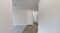 Located at 3701 S Orchard St in Tacoma, WA, this two-bedroom, two-bathroom unit offers a well-organized single-floor layout designed for comfortable everyday living. The spacious living room serves as the heart of the home, featuring plush carpeting, a classic fireplace with a glass-front surround, and a sliding glass door that brings in natural light. Baseboard heating is present throughout, ensuring year-round comfort. The kitchen is outfitted with white cabinetry, light stone-look countertops, a stainless steel sink, and light wood-look flooring, complemented by a skylight that brightens the workspace. Both bedrooms feature soft carpeting and sliding closet doors for ample storage. The primary bedroom stands out with direct access to a private bathroom, as well as a second door for added convenience. The bathrooms are finished with wood-look flooring, white vanity cabinetry, and light countertops. The full bathroom includes a shower-tub combination. Neutral tones and clean finishes are carried consistently throughout the unit, creating a cohesive and move-in ready atmosphere. The second bedroom offers a window with pleasant outdoor views, adding a sense of openness to the space.