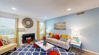 Located at 1500 Chase Arbor Common in Virginia Beach, VA, this 2-bedroom, 2-bathroom single-floor residence offers a well-organized and functional layout. The open-concept living and dining area serves as the heart of the home, featuring warm wood-look flooring, recessed lighting, and a textured ceiling. The living room is anchored by a classic fireplace and features a soft blue accent wall, creating a relaxed coastal ambiance, with natural light streaming in through the windows. The dining area flows seamlessly from the living space, offering a dedicated spot for everyday meals. The kitchen is equipped with wood cabinetry, granite-style countertops, stainless steel appliances including a range and dishwasher, and a window that brings in additional natural light. A separate pantry and laundry area add practical convenience. The primary bedroom provides a comfortable retreat with plush carpeting and a neutral accent wall, while three closets throughout the home ensure ample storage. The bathrooms are clean and functional, each featuring a tub-shower combination with white tile surround. A hallway connects the private quarters to the main living areas, completing this efficiently designed and move-in-ready Virginia Beach home.