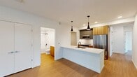 This contemporary apartment in Redmond, WA offers 1,130 square feet of well-designed living space. The open-concept layout showcases a sleek kitchen with modern appliances, wood cabinetry, and a large island with a sink, perfect for meal preparation and casual dining. The living area flows seamlessly from the kitchen, creating an ideal space for entertaining.

The apartment features four bedrooms, including a spacious primary bedroom of 190 square feet. Two full bathrooms provide ample convenience, with one showcasing a glass-enclosed shower and wooden vanity. The in-unit laundry room comes equipped with a stacked washer and dryer set.

Throughout the apartment, light wood flooring adds warmth and continuity. Large windows in the bedrooms and living areas allow natural light to flood the space, while a balcony offers outdoor access and city views. Modern amenities include recessed lighting, ceiling fans, and individual climate control units for year-round comfort.

The neutral color palette and clean lines create a contemporary aesthetic, providing a blank canvas for personal style. With its thoughtful design and convenient location at 16855 Redmond Way, this apartment offers a perfect blend of comfort and urban living in the heart of Redmond.