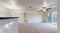 This 860 square foot apartment in Altamonte Springs, Florida, offers a well-planned living space with two bedrooms and two bathrooms. The layout maximizes functionality, featuring a combined kitchen and living area that opens to a balcony, providing natural light and outdoor views. The kitchen boasts light wood cabinetry, black appliances, and a practical design for easy meal preparation.

The primary bedroom, measuring 160 square feet, includes an en-suite bathroom and ample closet space. Both bedrooms are equipped with ceiling fans and plush carpeting for comfort. The bathrooms feature tiled surroundings and standard fixtures, with one offering a bathtub-shower combination.

Throughout the apartment, neutral tones dominate, creating a blank canvas for personal decor. The living areas and bedrooms are carpeted, while the kitchen and bathrooms have durable wood-look flooring. A separate laundry room with full-sized appliances adds convenience to daily life.

Storage is well-considered, with closets in both bedrooms and additional space in the hallway. The overall design prioritizes functionality and comfort, making efficient use of the available square footage to create a cozy yet practical living environment.