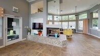 Located at 3021 SR-590 in Clearwater, Florida, this well-appointed single-floor residence offers a thoughtfully designed open-concept layout that seamlessly connects the main living areas. Dark hardwood-style flooring runs throughout the common spaces, creating a cohesive and polished aesthetic.

The kitchen is equipped with stainless steel appliances, including a refrigerator, range, and built-in microwave, complemented by dark cabinetry and granite-style countertops. A breakfast bar with bar stools opens directly to the dining area, which features a bold yellow accent wall, wainscoting detail, and space for a full dining set. An in-unit laundry area is conveniently accessible from the kitchen.

The living room is generously proportioned, anchored by a striking teal accent wall, dark hardwood-style flooring, a ceiling fan, and sliding glass doors that invite natural light. The bedroom features plush carpeting, a ceiling fan, bold accent wall, and sliding glass door access, lending a bright and comfortable atmosphere. The bathroom includes a granite-topped vanity with dark cabinetry, a tub-shower combination, and wood-style flooring.

Overall, the residence balances vibrant color choices with modern finishes, offering a functional and visually engaging living environment in the heart of Clearwater.