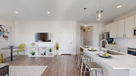Located in Mason, Ohio, this thoughtfully designed single-floor home offers a bright and modern living experience. The open-concept layout seamlessly connects the kitchen and living room, creating a spacious, airy feel throughout the main living area. The kitchen is a standout feature, showcasing crisp white cabinetry extending to the ceiling, a classic white subway tile backsplash, stainless steel appliances, and a central island with a built-in sink and seating — illuminated by a stylish pendant light. Hardwood-style flooring flows throughout the kitchen and living areas, adding warmth and continuity. The living room is generously sized and bathed in natural light from multiple windows, creating a welcoming and comfortable retreat. The bedroom offers plush carpeting, a ceiling fan, and dual windows that bring in abundant daylight. The full bathroom features a combined tub and shower unit with clean white finishes and hardwood-style flooring. Additional highlights include four closets for exceptional storage, a dedicated pantry, and a hallway connecting the private and shared spaces. The overall aesthetic is clean, contemporary, and move-in ready.