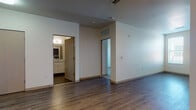Located at 2500 Rimrock Rd in Madison, Wisconsin, this single-floor unit offers a clean, modern design with a thoughtful layout throughout. The open living area is finished with rich hardwood-style flooring that extends across the main spaces, creating a cohesive and contemporary feel. Natural light filters in through well-placed windows, brightening the interior and adding warmth to the neutral color palette.

The kitchen is a standout feature, equipped with stainless steel appliances including a refrigerator, gas range, and microwave. Dark upper cabinetry contrasts stylishly with white lower cabinets, while granite countertops and a tiled backsplash complete the polished look. The adjoining living space flows seamlessly from the kitchen, offering a versatile and open floor plan.

The bedroom is carpeted for comfort and includes a window that allows in natural light, along with a closet for ample storage. The bathroom is finished with granite countertops, white cabinetry with brushed nickel hardware, a large mirror, and tile flooring, reflecting the same quality found throughout the unit.

Overall, this space presents a well-designed, modern interior with consistent finishes, functional room arrangements, and a bright, inviting ambiance.