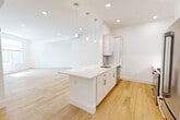 Located at 95 Fawcett St in Cambridge, MA, this thoughtfully designed 3-bedroom, 2-bathroom single-floor residence offers a clean, modern aesthetic throughout. Light hardwood flooring flows seamlessly across all rooms, complementing the crisp white walls and recessed lighting that create a bright, airy atmosphere.

The open-concept kitchen is a standout feature, boasting a central island with a white quartz countertop and undermount sink, white shaker cabinetry, a subway tile backsplash, and stainless steel appliances including a gas range, built-in microwave, and dishwasher. Pendant lighting above the island adds a stylish touch, while the layout opens directly into the spacious living area.

The generously sized primary bedroom offers ample room and is complemented by two additional well-proportioned bedrooms, each featuring natural light from large windows with blinds and recessed lighting. The two bathrooms are finished with clean, modern appointments — one features a walk-in glass-enclosed shower with marble-style tile surround, a white vanity with quartz countertop, and light tile flooring. The second bathroom mirrors this refined simplicity. A dedicated closet and practical layout round out this well-organized, move-in-ready Cambridge home.