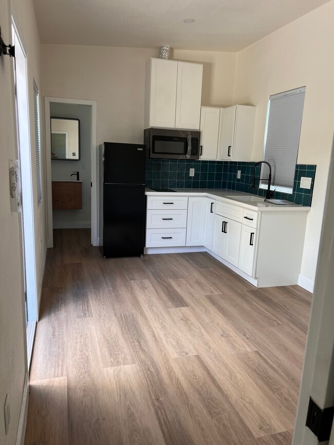 Kitchen and door to bathroom (forward) and front door (to left) - 1219 Laurel St