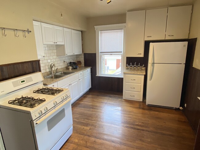 Large bright kitchen with fridge and gas stove. Plenty of cabinet space. - 1210 Clark Ave