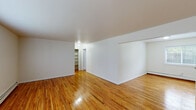 Located at 272 Ward Ave in Bordentown, NJ, this 2-bedroom, 1-bathroom residence offers a well-organized single-floor layout with a clean, neutral aesthetic throughout. Warm-toned hardwood floors extend across the living room and both bedrooms, lending a cohesive and inviting character to the space. The living room is generously sized, bathed in natural light through large windows, and features baseboard heating and a wall-mounted AC unit for year-round comfort. The primary bedroom is a comfortable, well-proportioned room with its own window and closet, while the second bedroom similarly benefits from natural light and hardwood flooring. A connecting hallway ties the rooms together seamlessly. The kitchen is efficiently designed with rich medium-toned wood cabinetry, dark countertops, and black appliances including a gas range, microwave, and refrigerator, all set atop tile flooring. The bathroom is bright and clean, featuring tile flooring, a window for natural ventilation, and a bathtub. Built-in shelving in the hallway adds practical storage. The overall ambiance is simple, clean, and functional, making this Bordentown residence a practical and comfortable home.