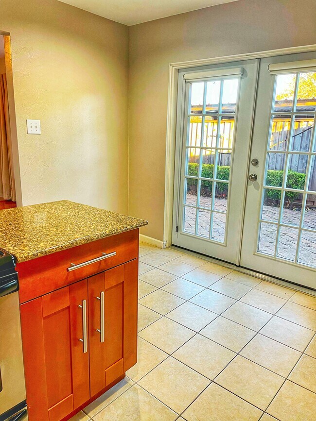 View from kitchen to breakfast nook and patio - 10714 Pagewood Dr