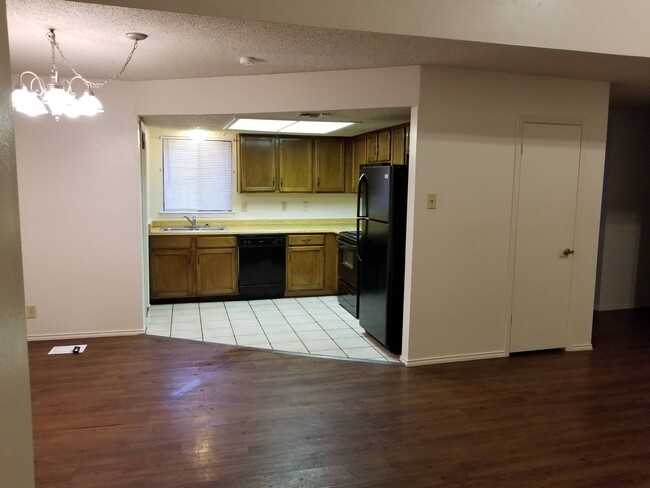 Kitchen has black appliances, built-in microwave, new cabinets countertops planned. - 7235 Rimwood St