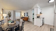 Located at 1030 S Dobson Rd in Mesa, Arizona, this one-bedroom, one-bathroom unit offers a thoughtfully laid-out single-floor design that maximizes every square foot. The open-concept living and dining area flows seamlessly from the kitchen, which features white shaker-style cabinetry, granite-look countertops, and stainless steel appliances. Light wood-look flooring runs through the kitchen and dining area, creating a clean and cohesive aesthetic. The living room is bright and welcoming, with natural light filtering in through windows dressed in neutral grommet curtains with blinds. Soft carpet underfoot adds warmth and comfort to both the living space and the bedroom. The bedroom is a quiet, well-proportioned retreat, featuring a window that draws in natural light, plush carpet, and a classic six-panel door providing easy access to the hallway. A dedicated closet adds practical storage. The bathroom is clean and simply designed, with a tiled tub-shower combination, wood-look tile flooring, and crisp white walls accented by bold black-and-white décor. A connecting hallway ties all rooms together efficiently. With a textured ceiling throughout and a neutral color palette, this unit offers a comfortable and functional living environment in the heart of Mesa.