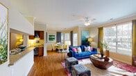 Located at 1200 Pickett Branch Rd in Cary, NC, this single-floor residence offers a thoughtfully designed layout that balances comfort and functionality. The open-concept living and dining area is bright and welcoming, featuring warm hardwood-style flooring, crown molding, and a ceiling fan. Large windows allow abundant natural light to fill the space, while a sliding glass door provides direct access to a private balcony with outdoor views. A bold accent wall in the living room adds a striking architectural detail.

The galley-style kitchen is efficiently designed with warm wood cabinetry, granite countertops, a double-basin sink, and black appliances, including a full-size refrigerator. A dedicated laundry closet with a full-size washer and dryer is conveniently accessible from the kitchen. Tile flooring completes the kitchen area.

The bedroom is a comfortable retreat with hardwood-style flooring, a ceiling fan, and a window with natural light. A walk-in closet provides generous storage with built-in shelving and hanging space.

The bathroom features tile flooring, a granite-topped wood vanity, a large mirror, and a full tub and shower combination. Throughout the residence, a cohesive neutral palette is complemented by warm wood tones, creating an inviting and well-balanced ambiance.