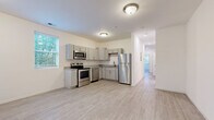 Located at 301 E Old Hickory Blvd in Nashville, TN, this 2-bedroom, 2-bathroom unit offers a thoughtfully designed single-floor layout with contemporary finishes throughout. Light wood-style flooring runs consistently across all rooms, creating a cohesive and clean aesthetic that enhances the sense of openness.

The kitchen is a standout feature, equipped with a full suite of stainless steel appliances including a range, over-the-range microwave, dishwasher, and refrigerator. Gray shaker-style cabinetry pairs with granite-look countertops, while multiple windows allow natural light to brighten the space. The adjacent dining area benefits from additional windows with views of surrounding greenery.

Both bedrooms are bright and functional, featuring light-toned walls and natural light from windows with blinds. The primary bedroom is a comfortable and efficient size, with its own dedicated closet. A second closet provides additional storage elsewhere in the unit.

The two bathrooms are finished with light, neutral tones. One features a tiled tub-and-shower combination with large-format wall tiles, a white vanity, and light wood-style flooring. A hallway connects the main living areas to the bedrooms and bathrooms, supporting a practical and efficient floor plan.