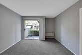 Located at 770 S Sherman Ave in Corona, CA, this one-bedroom, one-bathroom unit offers a compact and efficiently designed single-floor layout. The living area features soft carpeting, neutral gray walls, a textured ceiling, and a sliding glass door that fills the space with natural light while providing a view of the surrounding greenery. A wall-mounted HVAC unit keeps the space comfortable year-round.

The kitchen is thoughtfully appointed with white cabinetry, wood-look flooring, a stainless steel refrigerator, an electric range, and a single-basin sink with ample counter space — ideal for everyday cooking and meal preparation.

The bedroom is a comfortable size, dressed in plush carpeting with textured walls and a window that invites natural light. It connects to a generous walk-in closet outfitted with wrap-around hanging rods, providing practical and well-organized storage.

The bathroom includes a full tub-shower combination, a toilet, and a vanity with a stone-look countertop and mirror. Wood-look flooring ties the space together cleanly.

Overall, the unit presents a functional, move-in-ready layout with a clean, neutral palette and practical finishes throughout, situated in a residential neighborhood in Corona, California.