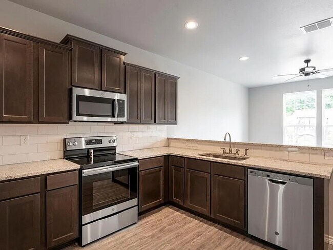 Kitchen with granite counters and modern appliances - 523 North St