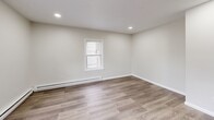 Located at 28-38 North St in Ware, MA, this thoughtfully updated one-bedroom, one-bathroom unit offers an efficient and well-designed layout across a single floor. The interior showcases consistent hardwood-style luxury vinyl plank flooring throughout, complemented by a neutral, light gray color palette that creates a clean and bright atmosphere.

The open living area benefits from multiple windows that invite natural light and offer views of the surrounding neighborhood. Recessed lighting and baseboard heating are present throughout, ensuring both comfort and functionality. The layout flows naturally into a kitchen equipped with white shaker-style cabinetry, a subway tile backsplash, modern countertops, and stainless steel appliances, providing a practical and attractive cooking space.

The bedroom is a generously proportioned room featuring dual windows, recessed lighting, and continued baseboard heating, offering a quiet and comfortable retreat. Crisp white trim and six-panel doors add a classic finishing touch to the space.

The bathroom is clean and functional, appointed with a full soaking tub and shower combination featuring a white surround with built-in shelving and brushed gold fixtures, adding a subtle touch of warmth to the space. Overall, this unit presents a move-in ready interior with modern updates throughout.