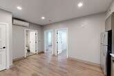 Located at 100 Hemenway Street in Boston's Fenway neighborhood, this 2-bedroom, 1-bathroom unit offers a well-designed layout with modern finishes throughout. The open-plan kitchen, dining, and living area serves as the heart of the home, featuring light wood-tone flooring, recessed lighting, and a sleek kitchen equipped with stainless steel appliances, two-tone cabinetry in white and gray, a marble-style quartz countertop, and a stainless undermount sink. The space is bright and functional, with a clean, contemporary aesthetic.

Both bedrooms are carpeted for comfort. The primary bedroom is a generous size, featuring a wall-mounted mini-split system, a double-door closet, and direct access to additional rooms. The second bedroom benefits from multiple windows that invite natural light and views of the surrounding greenery. A distinctive bay-windowed room provides an additional flexible space with ample natural light.

The bathroom is thoughtfully finished with subway tile in the walk-in shower, a mosaic tile shower floor, large-format floor tiles, and a warm wood vanity topped with a marble-style countertop. Three closets throughout the unit provide excellent storage. Recessed lighting and a neutral gray color palette create a cohesive, modern ambiance throughout.