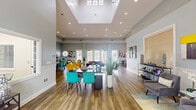 Located at 500 North Congress Avenue in Delray Beach, Florida, this single-floor community clubhouse offers a welcoming and well-appointed gathering space designed for both comfort and functionality. The layout flows seamlessly across its two main areas, beginning with a front reception zone that features an arched transom window above French doors, wainscoting along the lower walls, soft blue-gray paint, and a dedicated desk area ideal for leasing or administrative use. A pair of gray accent chairs and a round mirror complete the welcoming entrance atmosphere.

The space opens into a expansive great room distinguished by soaring ceilings with a prominent raised skylight that floods the interior with natural light. Recessed lighting throughout supplements the abundant daylight. Wide-plank wood-look flooring extends across the entire space, anchoring the open, airy feel. Multiple seating arrangements — including bold yellow armchairs, a slate-blue sofa with coral accents, and vibrant teal dining chairs — create distinct social zones within the open floor plan. Banks of French doors along the perimeter walls invite natural light from multiple directions and provide views of the surrounding greenery. A dining area with a dark table and teal chairs, a lounge corner, and a small refreshment station round out the amenities, making this clubhouse a dynamic and stylish communal hub.