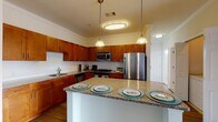 Located at 25 Glen Rock Road in Stamford, CT, this single-floor residence offers three bedrooms and two bathrooms thoughtfully arranged across a practical and well-finished floor plan. The kitchen serves as a central highlight, featuring warm medium-toned wood cabinetry, granite countertops with a subway tile backsplash, and a full suite of stainless steel appliances including a gas range, built-in microwave, and refrigerator. A peninsula with seating provides casual dining space while maintaining an open connection to the adjacent living area. Crown molding and pendant lighting add refined touches throughout.

The living room is bright and generously proportioned, with wood-style flooring, track lighting, and a sliding glass door that draws in natural light and provides outdoor access. The bedrooms are carpeted and well-sized, with large windows offering exterior views. Closet space is abundant, including a walk-in closet with wire shelving and additional rooms with double bi-fold closets. The bathrooms are clean and functional—one includes a tub-shower combination with white subway tile, while the other features a wide vanity with ample under-counter storage and a large mirror.