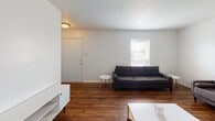 Located at 1465 Devon Ln in Harrisonburg, Virginia, this single-floor residence offers a practical and well-organized layout across several rooms. The living room greets occupants with rich hardwood flooring, neutral white walls, and a window that allows natural light to brighten the space, creating a clean and inviting atmosphere.

The kitchen is well-equipped, featuring warm honey-toned wood cabinetry, dark granite-style countertops, and a full suite of black appliances including an electric range with overhead microwave, dishwasher, and refrigerator. A window above the sink provides additional natural light, and the wood-look flooring ties the space together cohesively.

The residence includes multiple bedrooms, each carpeted for comfort and outfitted with windows fitted with blinds that offer both natural light and privacy. Several bedrooms are equipped with ceiling fans for climate control, and each room provides adequate space for sleeping and study arrangements.

The bathroom features a full tub-shower combination with clean white surrounds, standard fixtures, and hardwood-style flooring, offering a straightforward and functional design. Overall, this single-floor home presents a clean, no-frills layout well-suited for everyday living in the Harrisonburg area.