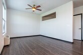 Located at 5123 Central Park Place in Fitchburg, Wisconsin, this efficiently designed single-floor studio offers a clean, contemporary aesthetic throughout. Dark-framed doors and trim create a striking contrast against crisp white walls, while durable wood-look flooring flows seamlessly across the entire space, lending a cohesive and modern feel.

The kitchen is a functional highlight, outfitted with white shaker-style cabinetry, light countertops, and a classic white subway tile backsplash. A full suite of stainless steel appliances — including a range, microwave, dishwasher, and refrigerator — provides everything needed for everyday cooking. A window positioned at the end of the kitchen draws in natural light and views of the outdoors.

The open living area benefits from a ceiling fan and a well-placed window that fills the room with natural light, creating a bright and airy atmosphere. The bathroom continues the modern design language with white cabinetry, a clean undermount sink, light countertops, and a frameless mirror. A closet offers practical storage within the compact footprint.

A private outdoor entry features a stone-accented landing with a dark metal railing, overlooking open green fields and a peaceful residential streetscape — providing a refreshing outdoor perspective unique to this ground-level unit.