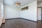 Located at 5123 Central Park Place in Fitchburg, Wisconsin, this efficiently designed single-floor studio offers a clean, contemporary aesthetic throughout. Dark-framed doors and trim create a striking contrast against crisp white walls, while durable wood-look flooring flows seamlessly across the entire space, lending a cohesive and modern feel.

The kitchen is a functional highlight, outfitted with white shaker-style cabinetry, light countertops, and a classic white subway tile backsplash. A full suite of stainless steel appliances — including a range, microwave, dishwasher, and refrigerator — provides everything needed for everyday cooking. A window positioned at the end of the kitchen draws in natural light and views of the outdoors.

The open living area benefits from a ceiling fan and a well-placed window that fills the room with natural light, creating a bright and airy atmosphere. The bathroom continues the modern design language with white cabinetry, a clean undermount sink, light countertops, and a frameless mirror. A closet offers practical storage within the compact footprint.

A private outdoor entry features a stone-accented landing with a dark metal railing, overlooking open green fields and a peaceful residential streetscape — providing a refreshing outdoor perspective unique to this ground-level unit.