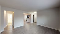 This single-floor residence offers a thoughtfully designed layout with a clean, neutral aesthetic throughout. The open living area features durable wood-style flooring, crisp white baseboards, and soft gray walls that create a bright and welcoming atmosphere. A ceiling fan adds both function and character to the dining area, which flows seamlessly into the kitchen via a convenient breakfast bar — ideal for casual dining or entertaining.

The kitchen is well-equipped and efficiently laid out, showcasing rich dark espresso cabinetry, granite-style countertops, a stainless steel refrigerator, gas range, and a window that invites natural light into the space. Ample cabinet storage lines the walls, providing generous room for organization.

The two bedrooms are comfortably sized, each featuring plush carpeting, ceiling fans, radiator heating units, and windows that allow natural light to filter in. The rooms offer a cozy and restful environment well-suited for relaxation.

The full bathroom is finished with classic white subway tile surrounding the tub-shower combination, complemented by a dark-toned vanity and wood-style flooring. A window provides ventilation and natural light.

Throughout the unit, a consistent design palette of neutral tones, modern fixtures, and functional finishes creates a cohesive and move-in-ready living environment.