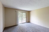 Located at 9412 N Avenue Plaza in Omaha, Nebraska, this 2-bedroom, 2-bathroom unit offers a practical and comfortable single-floor layout. The living area is carpeted and filled with natural light, highlighted by a sliding glass door that opens to a private balcony overlooking mature trees, creating a pleasant outdoor connection. A ceiling fan adds to the comfort of the living space, which flows seamlessly from the entryway featuring durable wood-look flooring at the threshold.

The galley-style kitchen is well-equipped with warm oak cabinetry, white countertops, light wood-look flooring, and black appliances including a range and dishwasher. A skylight-style overhead light brightens the kitchen, making it a functional workspace.

Both bedrooms are carpeted and feature neutral walls and windows that bring in natural light, giving each room a calm, airy feel. The primary bedroom offers a comfortable amount of space, while the second bedroom is similarly appointed. A dedicated closet provides additional storage.

The two bathrooms are clean and simply designed, with one featuring a vanity with a wood-toned cabinet, a countertop sink, a mirror, and a towel bar — all set against neutral-toned walls and wood-look flooring. The overall aesthetic throughout the unit is understated and move-in ready.