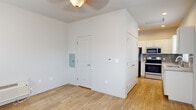 Located along US-24 W in Colorado Springs, Colorado, this single-floor unit offers a well-designed, move-in-ready layout with a cohesive neutral color palette and light hardwood flooring that flows seamlessly throughout the space.

The kitchen is a standout feature, outfitted with white shaker-style cabinetry, granite countertops, a gray subway tile backsplash, and a full suite of stainless steel appliances including a refrigerator, electric range, and over-the-range microwave. A double-basin stainless steel sink sits beneath a window fitted with blinds, allowing natural light to fill the space.

The main living area is open and bright, benefiting from two generously sized windows that bring in ample natural light and provide views of the surrounding neighborhood. A ceiling fan with a light fixture adds both function and character to the room. The space also includes a dedicated electrical panel and a programmable thermostat for added convenience.

The bathroom is neatly appointed with a dark wood vanity, granite countertop, and a window that introduces additional natural light. Hardwood flooring continues into this room, maintaining a consistent aesthetic throughout.

Large double-door storage adds practical utility, while recessed lighting in the kitchen area enhances the overall brightness and functionality of this thoughtfully designed space.