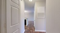 Located at 565 Saint Johns Avenue SW in Atlanta, GA, this single-floor, one-bedroom, one-bathroom home offers a well-organized layout across a comfortable footprint. Rich hardwood-style flooring flows through the main living areas, complemented by neutral wall tones that create a clean, cohesive aesthetic throughout.

The open-concept living, dining, and kitchen area serves as the heart of the home. The living room is bright and airy, featuring a ceiling fan and multiple windows dressed with blinds that invite generous natural light and views of the surrounding neighborhood. A pass-through breakfast bar connects the living and dining spaces to the kitchen, which is equipped with white cabinetry, a tile mosaic backsplash, light countertops, and black appliances including a range and dishwasher.

The bedroom is a well-sized retreat finished with plush carpet, a ceiling fan, and a large window that fills the room with natural light. Double doors open into a dedicated walk-in closet outfitted with wire shelving for ample storage. The full bathroom includes a tub/shower combination. Additional conveniences include a dedicated laundry area and hallway. The entry corridor features wood-look flooring and a practical layout that leads seamlessly into the main living space.