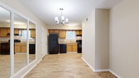 Located at 2355 W Michigan Ave in Pensacola, FL, this single-story, 2-bedroom, 2-bathroom home offers a practical and well-organized layout. Wood-look flooring flows consistently throughout the living areas, bedrooms, hallway, and kitchen, lending a cohesive, clean aesthetic to the entire space.

The living room is bright and open, featuring a sliding glass door that fills the room with natural light and provides views of the surrounding greenery outside. Adjacent to the living area, the dining room connects seamlessly to the kitchen, which is equipped with warm honey-toned cabinetry, black appliances including a refrigerator, dishwasher, and range, a single-basin sink beneath a window, and a stylish chandelier overhead.

The primary bedroom is generously sized, featuring two windows that invite ample natural light and a ceiling fan with light fixture. A mirrored sliding-door closet adds both storage and visual depth to the room. The second bedroom also includes a ceiling fan and maintains the same neutral, warm tones found throughout the home.

Both bathrooms are finished with white cabinetry, granite-style countertops, and a tub-shower combination. The neutral color palette and consistent flooring throughout create a calm and inviting atmosphere suited for comfortable everyday living.