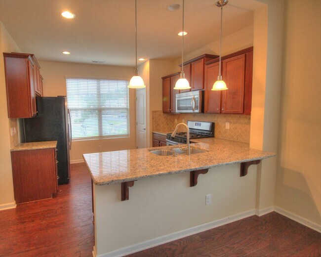 Photo - End Unit Townhome with Screened Porch & Fenced Yard!