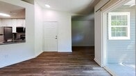 Located at 1423 Teal Trce in Pittsburgh, Pennsylvania, this efficiently designed 610-square-foot, single-floor apartment offers 1 bedroom and 1 bathroom. The open-concept kitchen and living area is anchored by a well-appointed kitchen featuring white shaker-style cabinetry, gray countertops, stainless steel appliances including a refrigerator, electric range, and over-the-range microwave, complemented by wood-look vinyl plank flooring. The living area extends naturally from the kitchen and includes a sliding glass door that opens to a private balcony with outdoor views, filling the space with natural light. A secondary area with wood-look flooring serves as a flexible dining or additional living space, also featuring a sliding glass door to the balcony. The 140-square-foot bedroom is carpeted, offering a cozy feel, and includes a mirrored sliding door closet. The full bathroom is finished with tile surrounding the shower/tub combo, a white vanity with ample storage, and gray tile flooring. Textured ceilings are present throughout. The unit's neutral color palette and consistent finishes create a clean, move-in-ready atmosphere throughout.