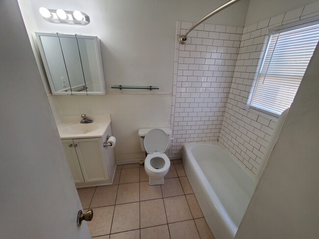 Bathroom with tile floor and shower, electric in ceiling heater for winter comfort. - 112 Oak St