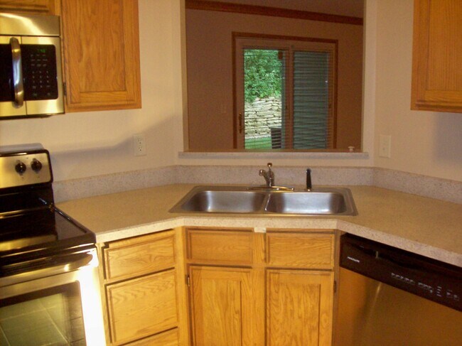 Kitchen looks out to dining room and patio door - 3545 Blue Jay Way