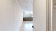 This thoughtfully designed studio in Memphis, TN offers a smart, open-concept layout that maximizes every square foot. Light hardwood flooring runs throughout the main living area, complemented by neutral white walls and a textured ceiling that add depth and warmth to the space. A large window fitted with blinds fills the room with natural light while offering views of the surrounding neighborhood, and track lighting and a modern sputnik chandelier provide stylish overhead illumination.

The kitchen is a standout feature, boasting crisp white shaker cabinets, a bold black hexagonal tile backsplash, a stainless steel range, and a tile countertop with integrated sink. A full-size stainless steel refrigerator anchors the kitchen wall, and a convenient in-unit washer is seamlessly incorporated into the cabinetry—an exceptional amenity for a studio of this scale.

The bathroom is elegantly finished with white shiplap-style walls, a soaking tub and shower combination clad in marble-look surrounds, matte black fixtures and towel bars, and natural wood accents that add a warm, modern touch. A dedicated closet provides practical storage. This well-appointed studio delivers a clean, modern aesthetic with carefully curated finishes throughout.