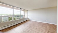 Located on the 8th floor at 765 Wonderland Rd S in London, Ontario, this well-appointed one-bedroom, one-bathroom unit offers a comfortable and efficiently designed layout across a single floor. Light wood laminate flooring runs throughout, lending a clean, cohesive feel to the entire space.

The living room is a standout area, featuring a large floor-to-ceiling window that floods the room with natural light and frames sweeping outdoor views of the surrounding greenery and cityscape. A baseboard heating unit runs along the window wall, ensuring year-round comfort. The open layout easily accommodates a variety of furniture arrangements.

Adjacent to the living area, the dining space features a classic pendant light fixture overhead and connects seamlessly to the kitchen. The kitchen is equipped with white cabinetry, an electric range, and a refrigerator, offering practical functionality in a compact footprint.

The bedroom is a calm and private retreat, finished with the same light wood flooring and neutral wall tones. It includes a built-in double closet with panelled doors, providing ample storage.

The bathroom is neatly appointed with a white vanity featuring under-sink storage, a wall-mounted mirror with a multi-bulb light fixture above, and warm wood-toned flooring. A welcoming hallway with a bright outlook connects all areas of the unit, completing this thoughtfully arranged home.
