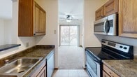 This 790 square foot apartment in Madison, WI offers a practical and comfortable living space. The single-story layout includes two bedrooms, with the primary bedroom spanning a generous 160 square feet. The apartment features one bathroom, equipped with modern fixtures including a combined tub and shower unit, and a vanity with ample counter space.

The kitchen is a highlight, boasting wooden cabinetry, granite-look countertops, and stainless steel appliances including a refrigerator, stove, and over-the-range microwave. The galley-style layout maximizes efficiency while providing adequate storage and prep space.

The living area is bright and inviting, with large windows allowing natural light to flood the space. Plush carpeting throughout the bedrooms and living areas adds warmth and comfort. Each bedroom features a closet for storage, and the apartment includes two additional closet spaces for extra organization.

A notable feature is the balcony or patio access, visible from the kitchen, which provides a connection to the outdoors and potential for fresh air and views. The apartment's neutral color palette and clean lines create a versatile canvas for various decorating styles. Overall, this apartment offers a well-designed living space with modern amenities in a convenient Madison location.