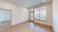 This contemporary apartment, located at 4000 Aspen Grove Dr in Franklin, TN, offers 940 square feet of thoughtfully designed living space. The open-concept floor plan seamlessly integrates the kitchen, living, and dining areas, creating an expansive feel. The kitchen is a highlight, featuring a large central island, stainless steel appliances, and ample cabinetry with a sleek, modern aesthetic.

Throughout the apartment, wood-look flooring adds warmth and durability. Large windows in every room, including floor-to-ceiling options in some areas, flood the space with natural light and offer pleasant views. The primary bedroom, measuring 160 square feet, provides a generous retreat.

Both bathrooms are well-appointed with modern fixtures, including double vanities in at least one. The apartment also boasts two closets, offering excellent storage solutions. Recessed lighting and contemporary ceiling fans contribute to the overall modern ambiance.

This single-story unit combines style and functionality, making efficient use of its 940 square feet to create a comfortable and inviting living environment in a desirable Franklin location.