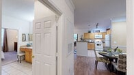 Located at 10300 Pine Lakes Ct in Raleigh, NC, this well-appointed 2-bedroom, 2-bathroom single-floor residence offers a thoughtfully designed layout with a comfortable, functional flow throughout. The open-concept living and dining area is anchored by warm wood-style flooring, crown molding, and decorative columns that lend an elegant touch. Large windows invite an abundance of natural light, creating a bright and welcoming ambiance across the main living spaces. The kitchen features light maple cabinetry, dark granite-style countertops, tile flooring, and a full suite of white appliances including a refrigerator, stove, and built-in microwave. A dedicated dining room with chair-rail molding provides a defined space for meals and entertaining. Both bedrooms are carpeted and generously sized, each offering multiple windows with outdoor views and ample closet space. The primary bedroom provides a comfortable retreat with room for a full furniture suite. Two bathrooms include tile flooring and vanities with extended countertops. Practical amenities include a dedicated in-unit laundry area with a full-size washer and dryer. With two closets and a well-organized floor plan, this residence offers efficient use of space throughout.